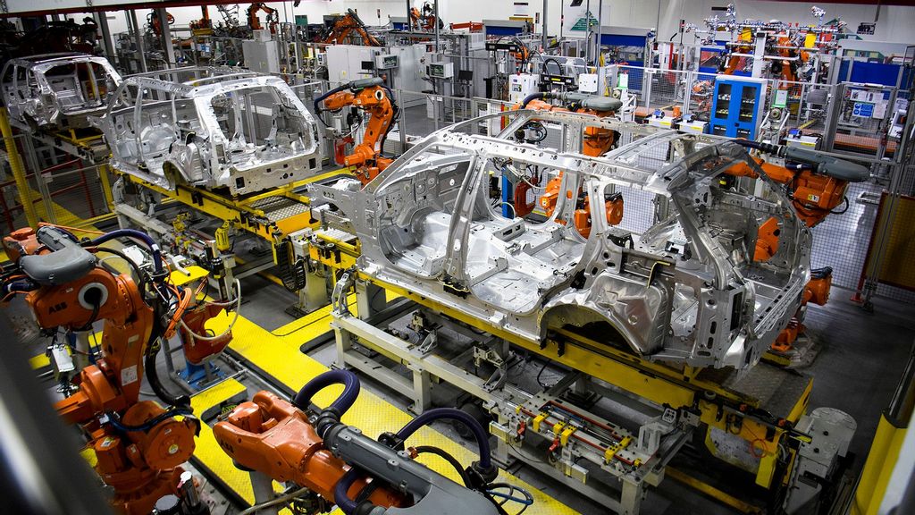 Robotic systems work on the chassis of a car during an automated stage of production at the Jaguar Land Rover factory in Solihull, England. (Leon Neal/Getty Images)
