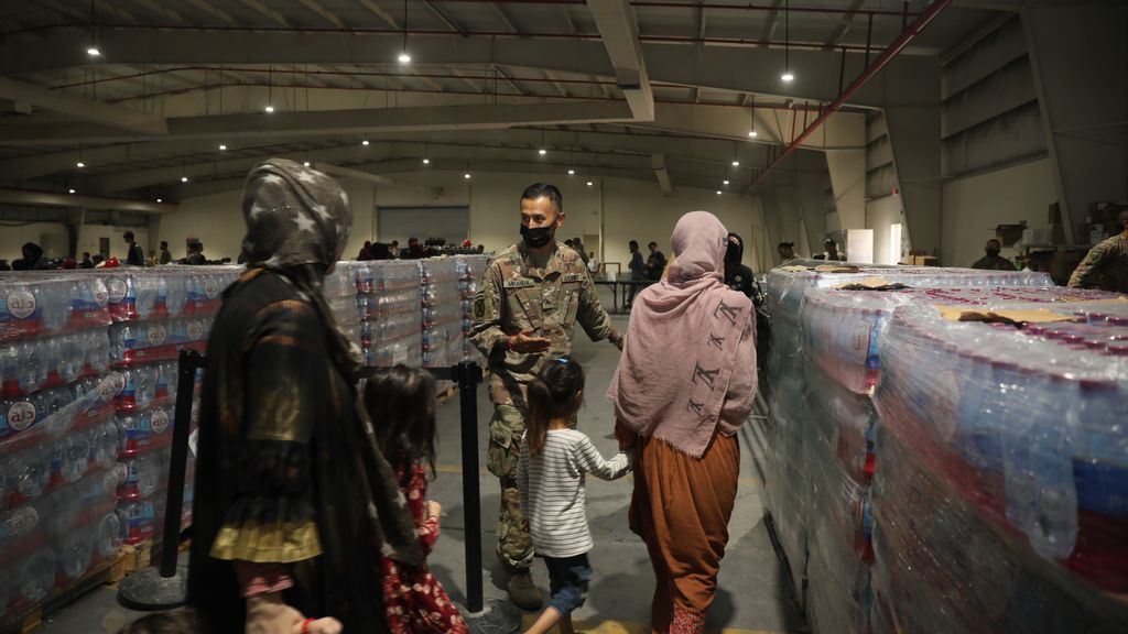 Afghan evacuees being directed into a dining area at Camp As Sayliyah in Doha, Qatar on August 20, 2021. (Jimmie Baker, U.S. Army/Getty Images)