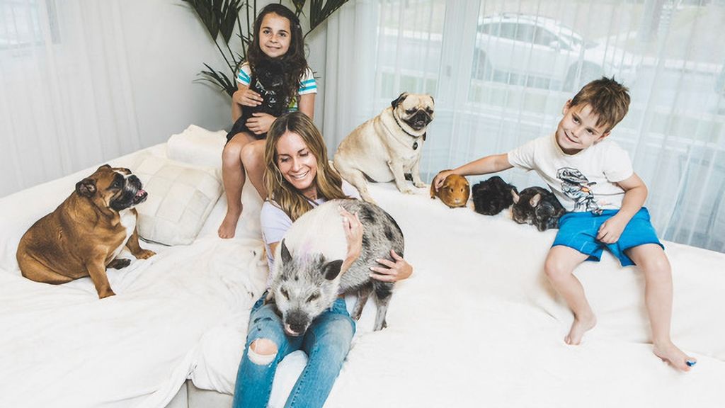 Melissa Cristofaro Trihey with her children and a few of their 14 pets, at home in Montreal, Canada. (@furballsinc/Zenger)